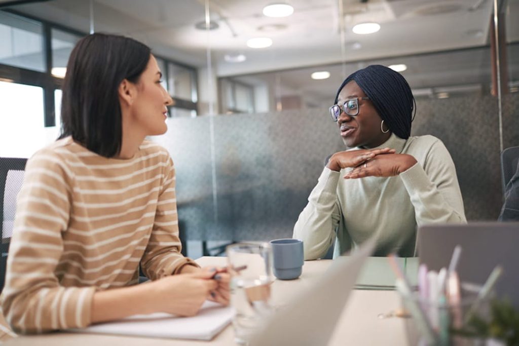 Women of diverse age discussing long-term financial planning and financial stability later in life.
