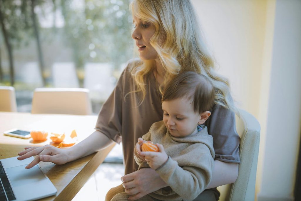 Parent organising household finances with child present